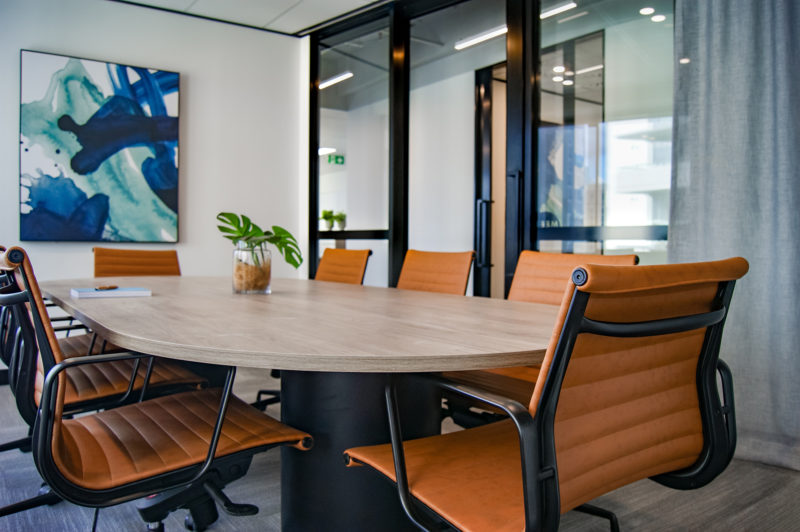 chairs around wooden table in office